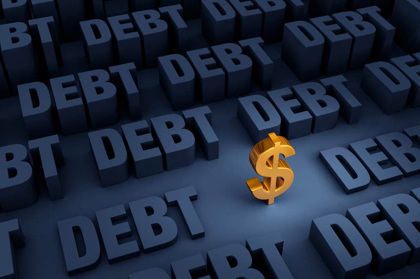 A small, gold dollar sign stands in a dark background of gray "DEBT" rising up around it.
