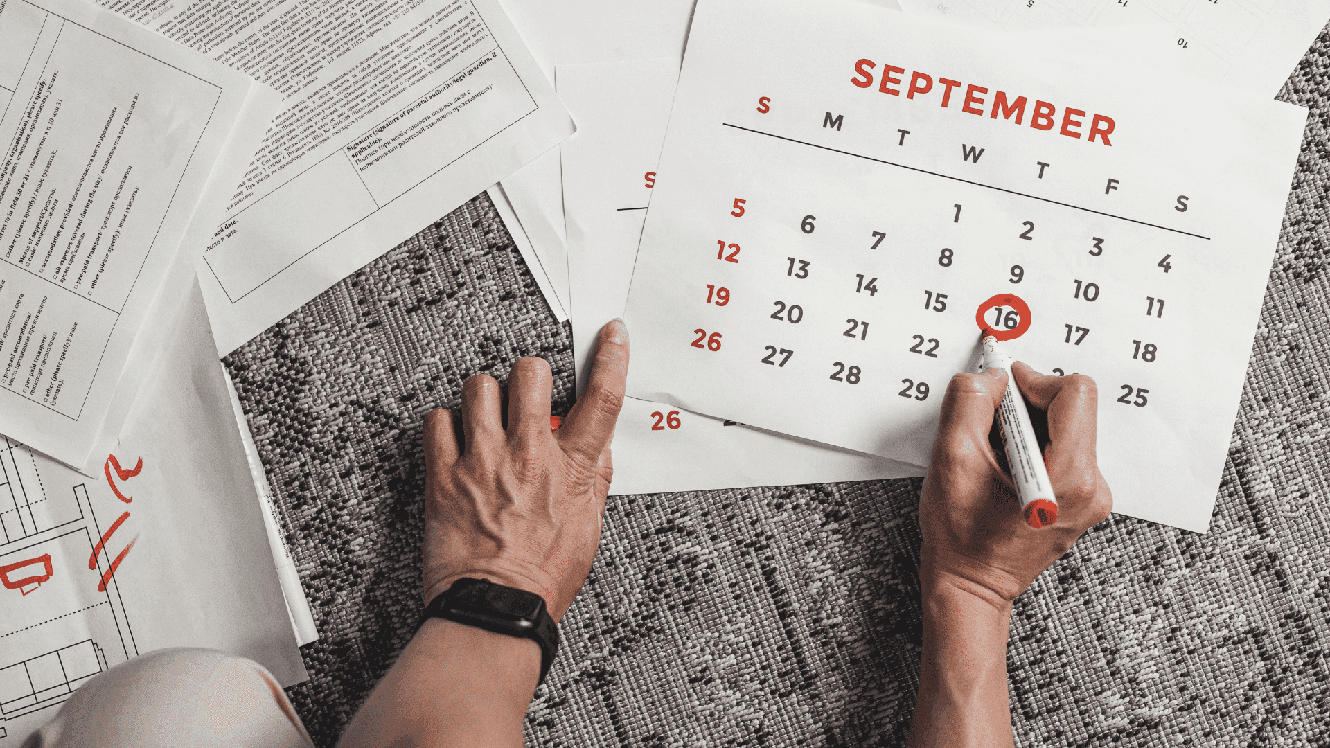 Person circling a date on a calendar beside paperwork, representing the importance of the date last insured in an SSDI claim.