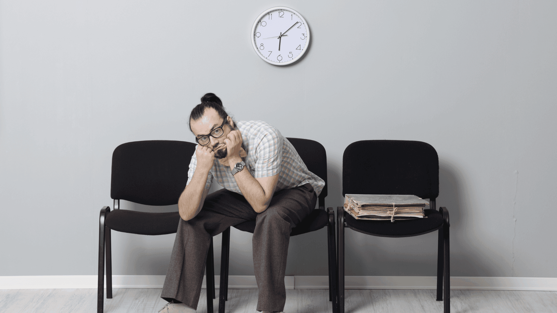 Man waiting beneath a clock beside case files, illustrating the timeline of an Alabama personal injury claim.