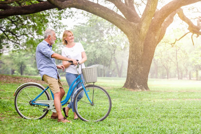 Senior couple in Alabama walking their bike