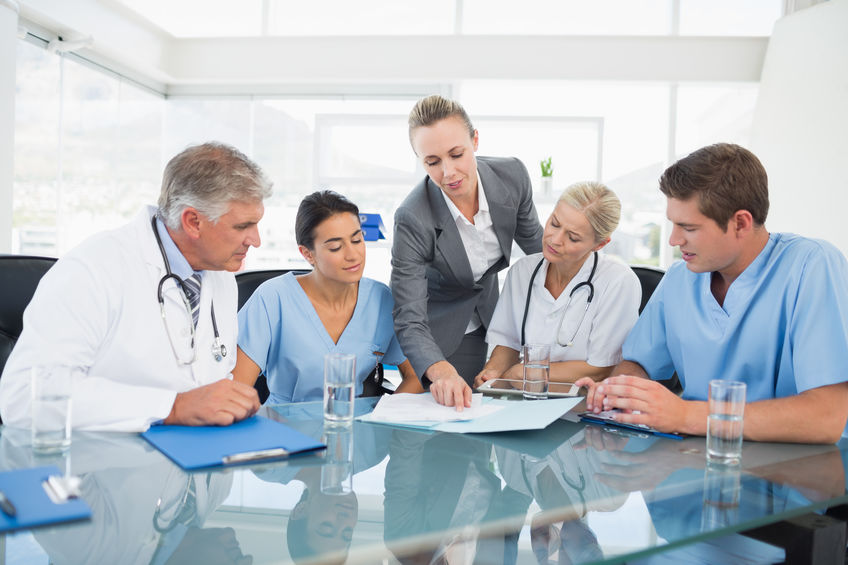 Team of doctors and businesswoman having a meeting in medical office