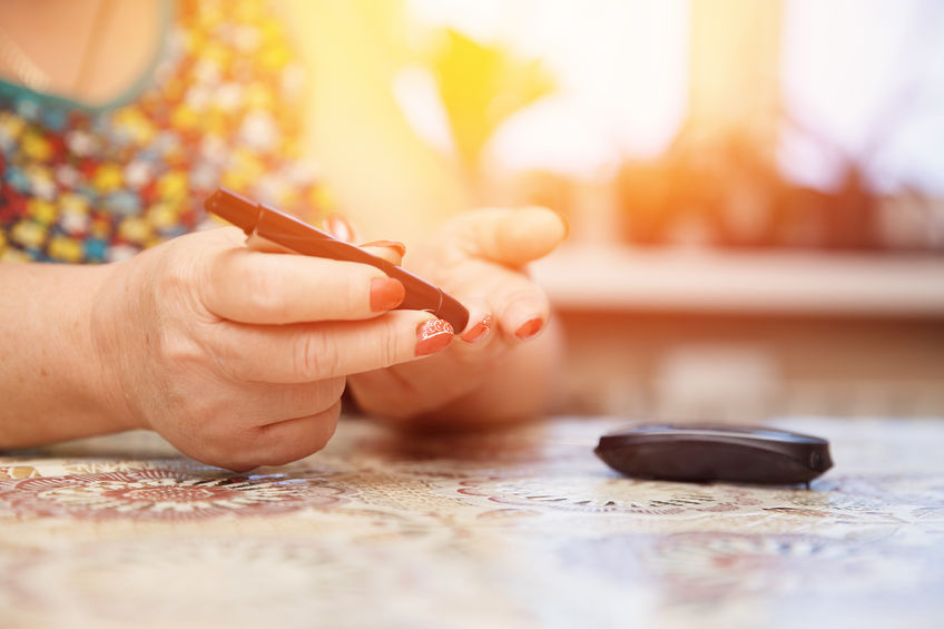 Glucometer. Woman checks blood sugar level for diabetes, insulin levels