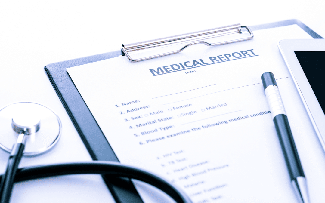 Medical report form on a clipboard next to a pen, tablet, and stethoscope for a Social Security Disability claim.